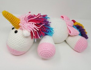 Rainbow Cuddles Stuffed Crochet Unicorn with Bow on Tail Project (side view) a chick crafting through Rheumatoid Arthritis cRAfterChick.com